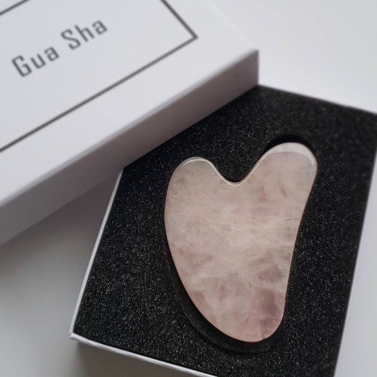 box containing a gua sha facial massage tool for the skincare tools category